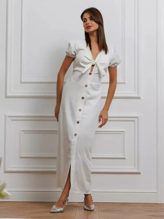Maxi Dress Pearl Whisper in white with tie-front bodice, puff sleeves, and button-down skirt in stylish interior setting.