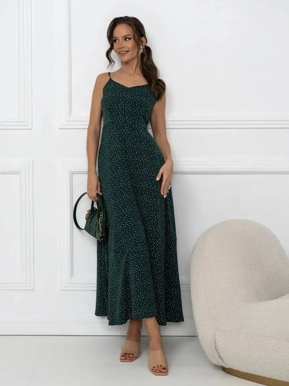 Emerald Whisper Maxi Dress showcasing A-line silhouette, back tie detail, and dotted print on a stylish model.