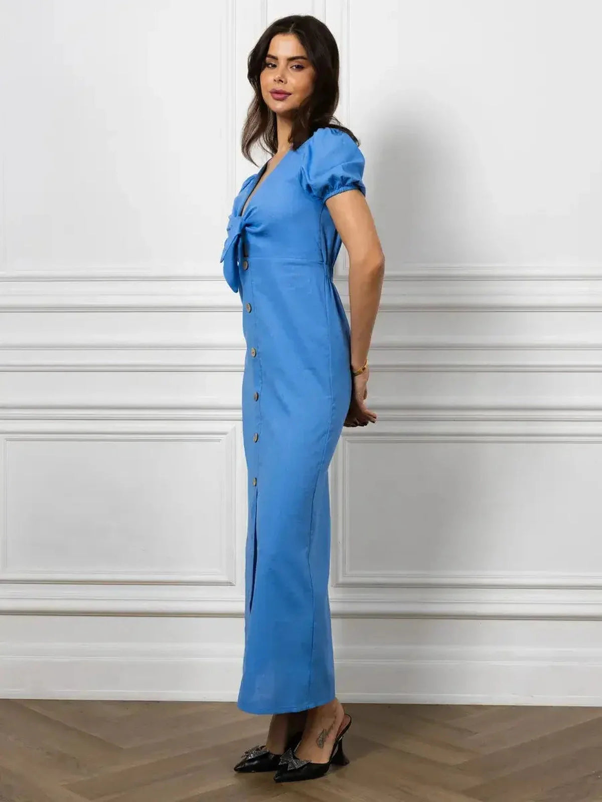 Maxi Dress Azure Charm featuring V-neck, tie-front detail, and buttons, styled elegantly in sky blue.
