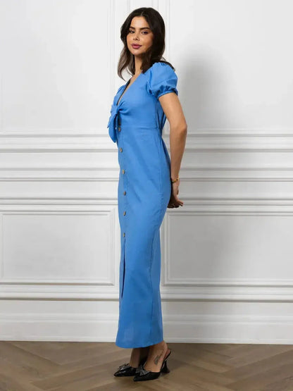 Maxi Dress Azure Charm featuring V-neck, tie-front detail, and buttons, styled elegantly in sky blue.