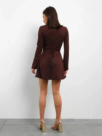 Back view of Cocoa Laced mini dress, featuring a lace-up detail and long sleeves in rich chocolate tone.