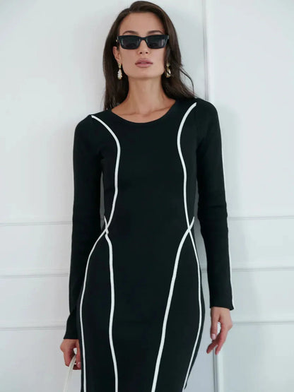 Model wearing the Midnight Curve Maxi Dress with white piping, showcasing its sculpting silhouette and elegant lines.