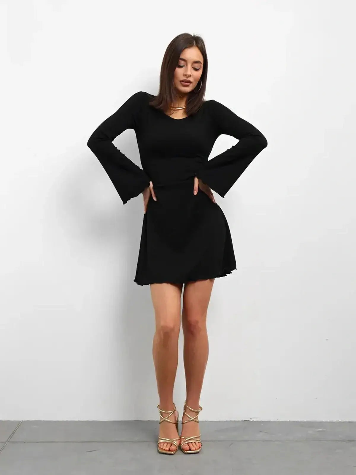 Elegant black mini dress with flared long sleeves, perfect for weddings, parties, or casual outings.