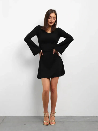 Elegant black mini dress with flared long sleeves, perfect for weddings, parties, or casual outings.