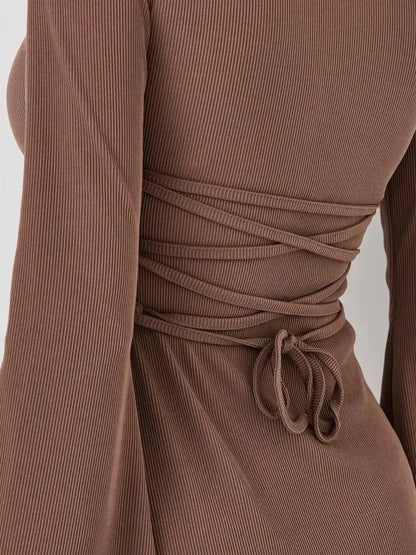 Close-up of Mocha Flare mini dress showing detailed tie-back design and soft flared long sleeves in rich coffee tone.