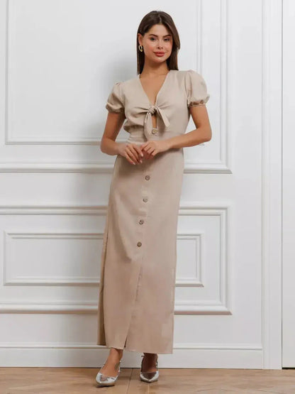 Elegant Serene Bond Maxi Dress with puff sleeves and waist tie, perfect for warm-weather events or chic everyday wear.
