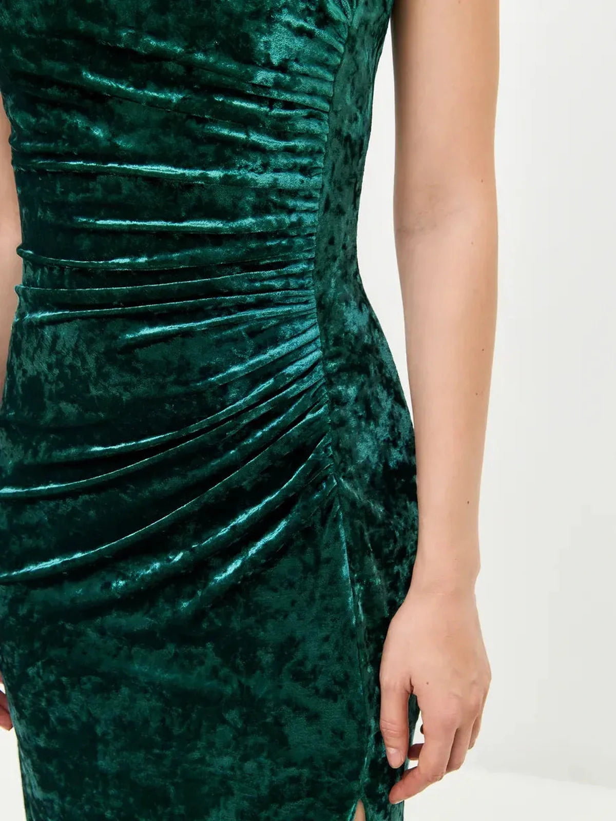 Close-up of the Velvet Aura Maxi Dress showcasing the lush green velvet fabric and elegant ruching details.