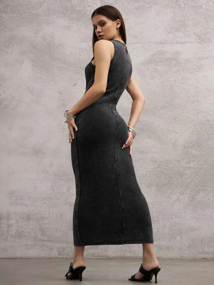 Model showcasing the Shadow Curve Maxi Dress in graphite, highlighting its sleeveless design and bodycon fit.