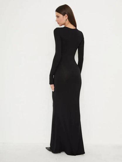 Elegant full-length black dress, Sculpted Noir, showcasing a smooth silhouette and mermaid hem in a minimalist design.