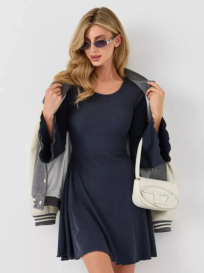 Stylish model wearing a navy ribbed mini dress, paired with a jacket and sunglasses, showcasing effortless elegance.