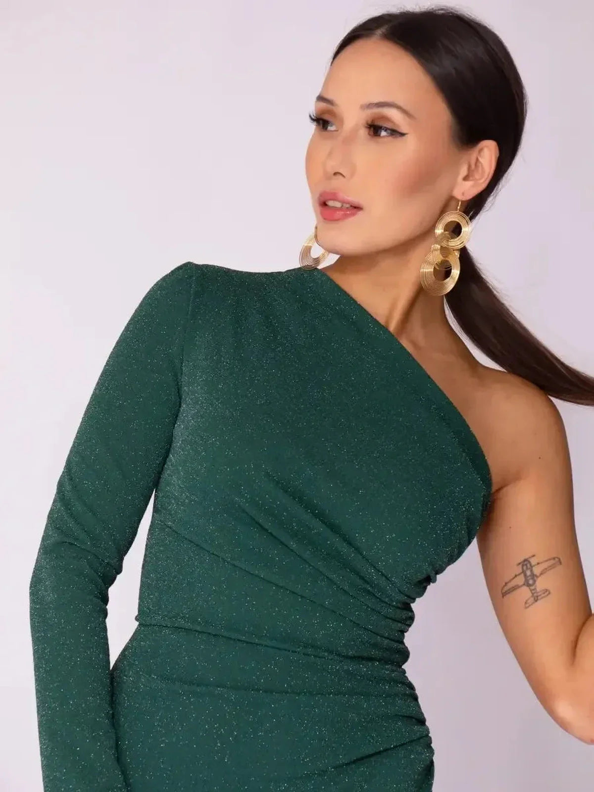 Emerald Spark Maxi Dress showcasing one-shoulder design with shimmer, perfect for modern glam and elegant occasions.