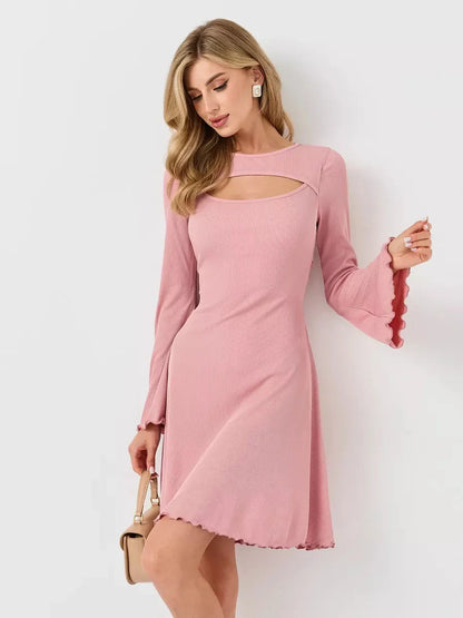 Model showcasing the Blush Whisper pink summer dress with flared sleeves and U-neckline, highlighting its sculpting charm.