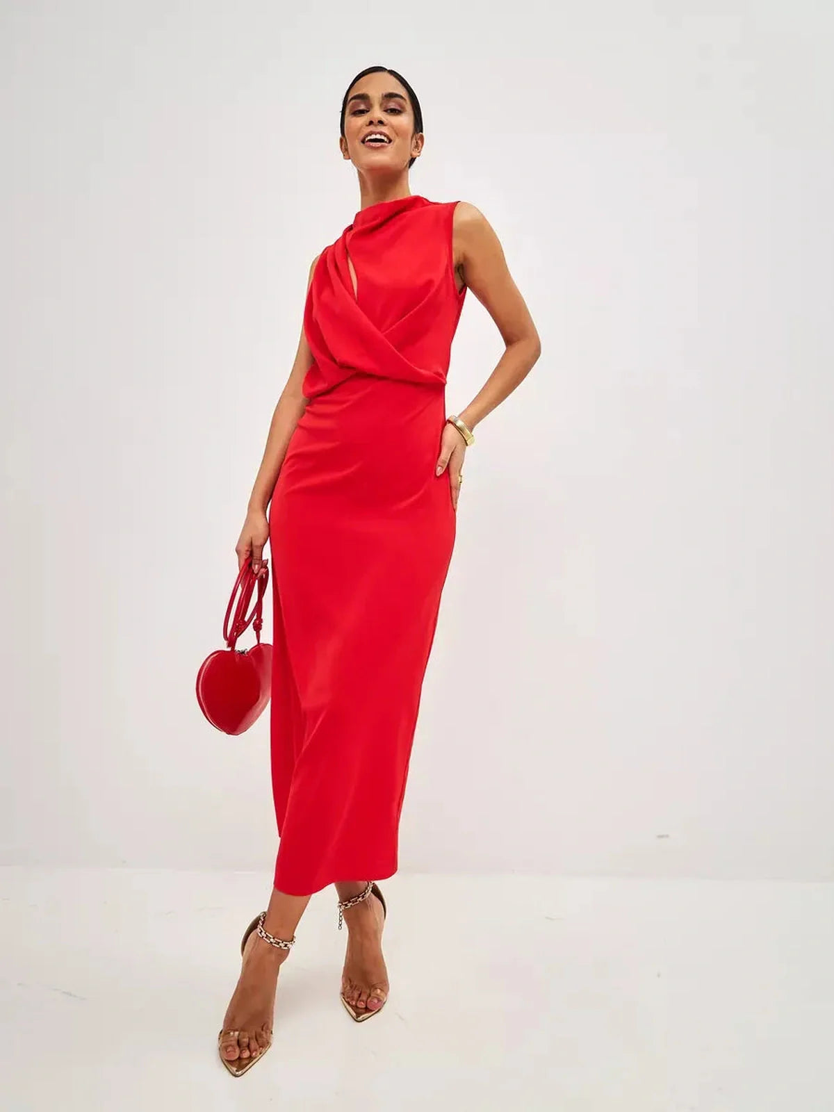 Stylish model wearing a sleeveless red drape maxi dress, showcasing a sophisticated silhouette and elegant neckline.