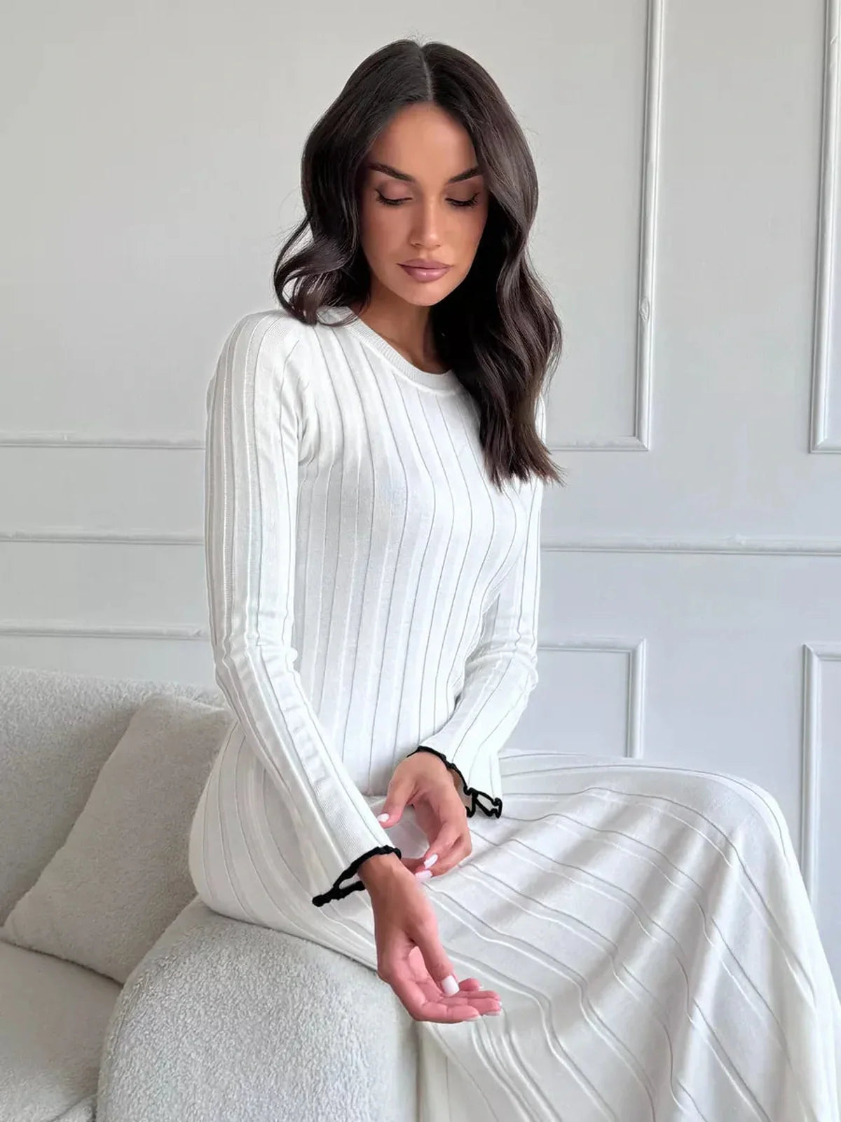 Model wearing Ivory Grace Maxi Dress with ribbed texture and ruffle trim, showcasing chic elegance and comfort.