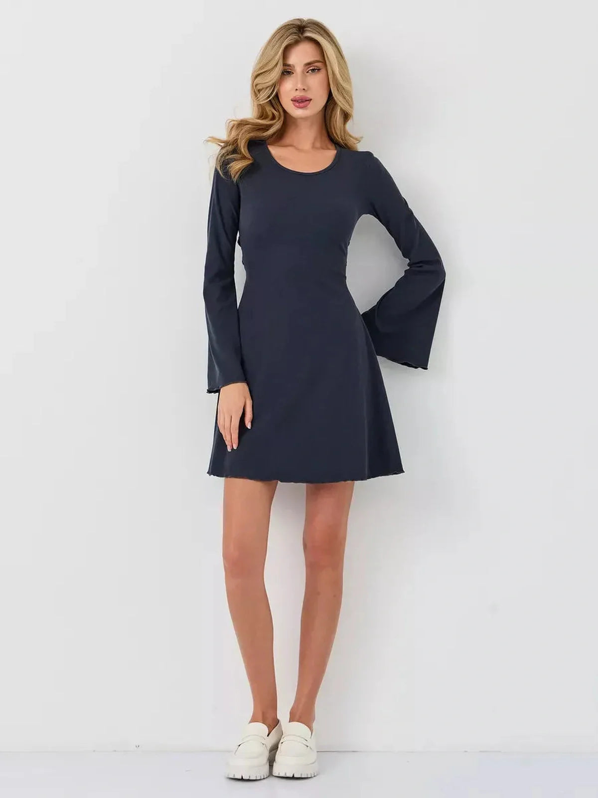 Graphite Grace mini dress in dark blue with flared sleeves, showcasing a flattering A-line silhouette.