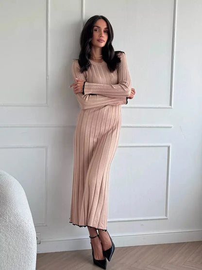 Model wearing Sahara Curve Maxi Dress in sandstone beige, showcasing its ribbed texture and elegant full-length silhouette.