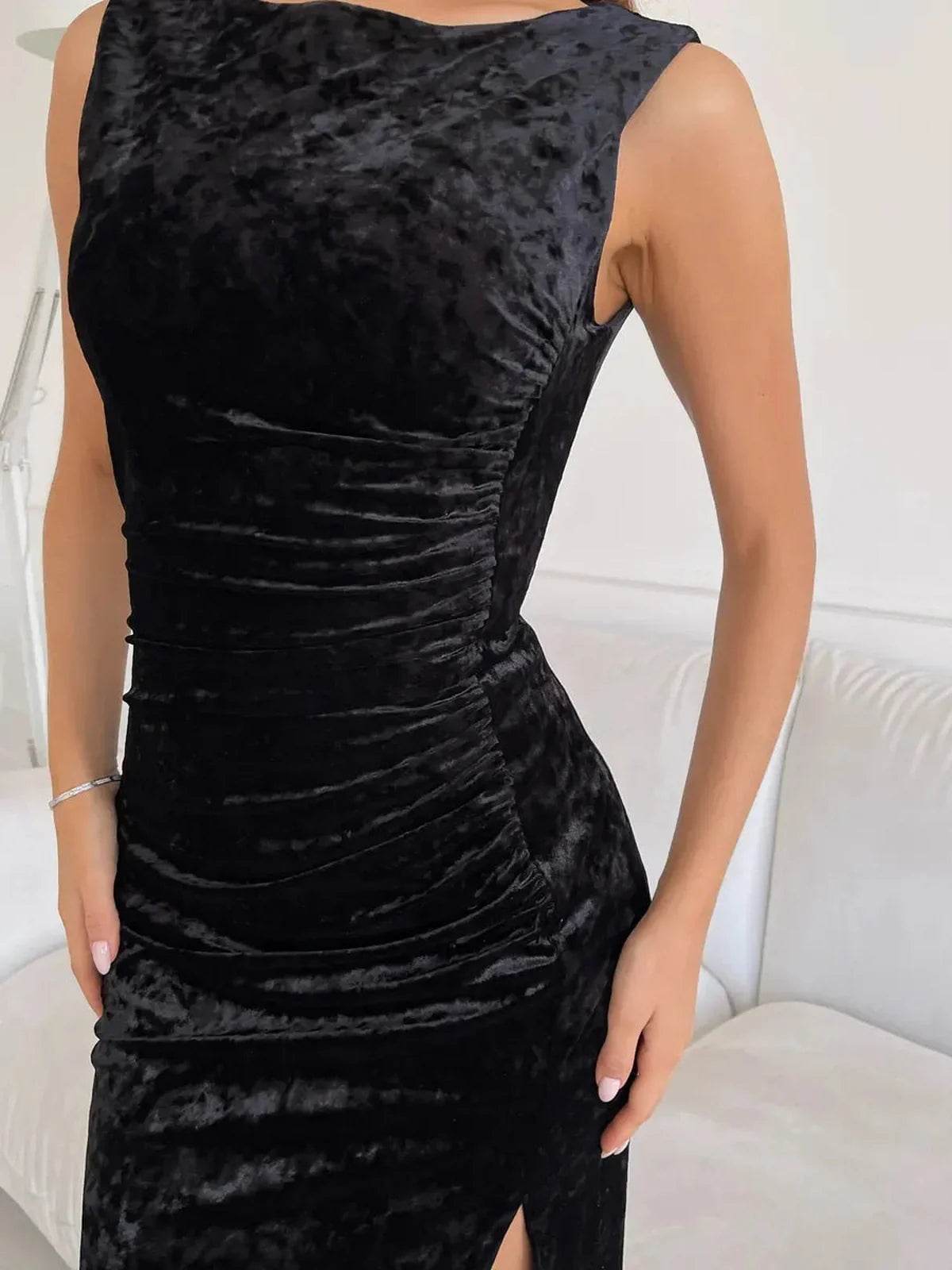 Close-up of Noir Muse Maxi Dress in black velvet, featuring sculpted fit and thigh-high slit for elegance.