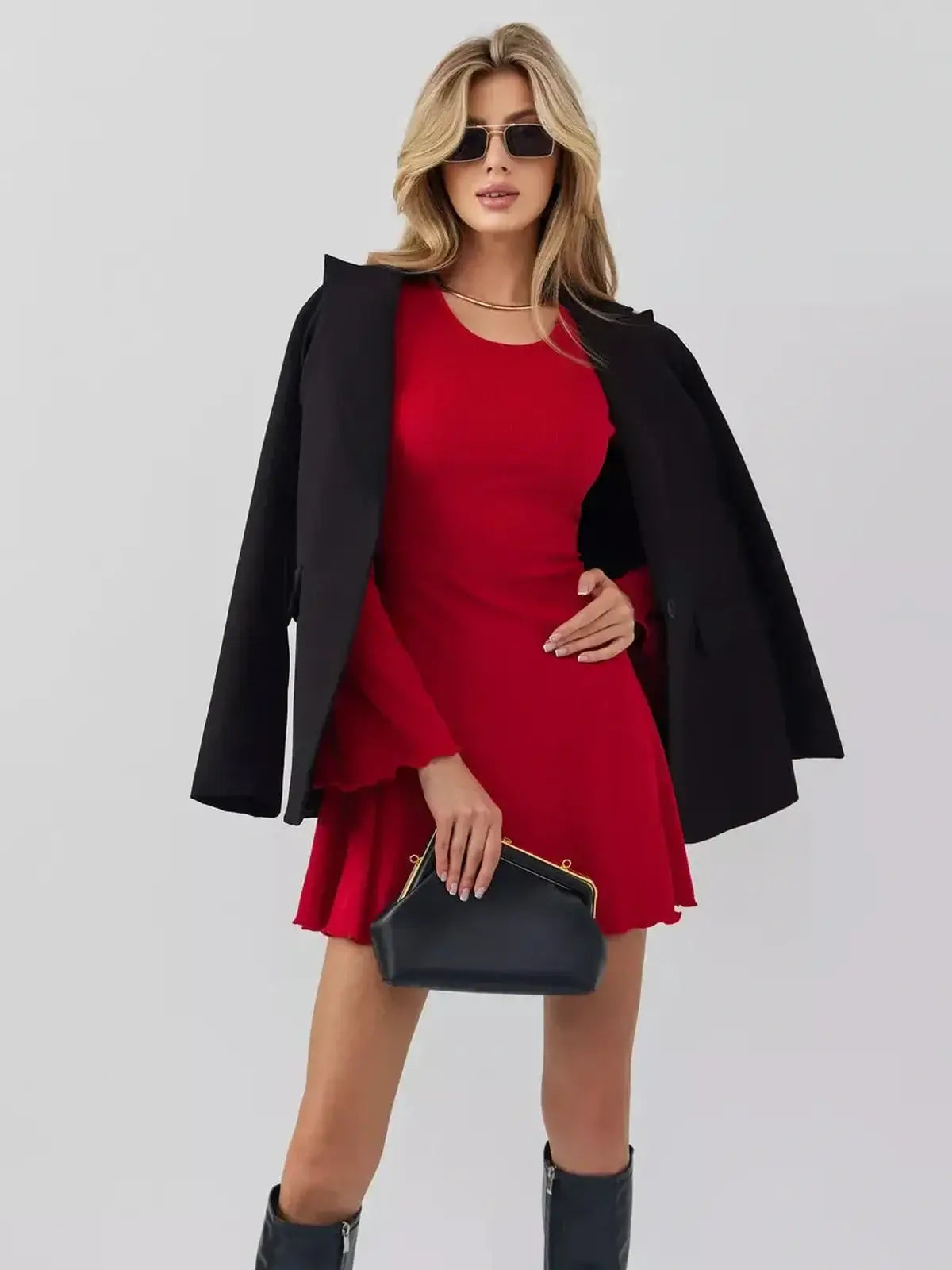 Stylish model in a red mini dress with black blazer and handbag, perfect for cocktail or summer occasions.