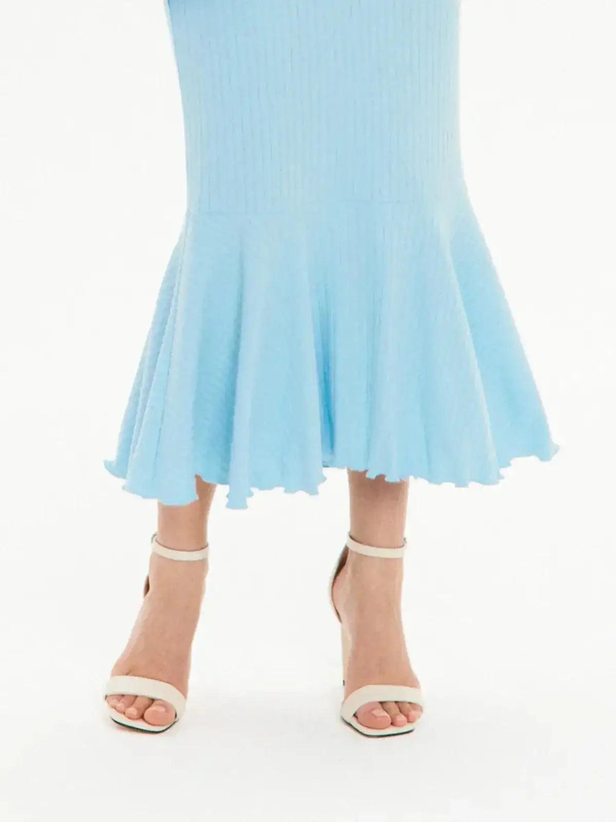 Light blue long sleeve midi dress with flared hem, styled with strappy high-heeled sandals for elegant looks.