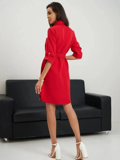 Scarlet belted mini dress showcasing a sculpted fit and elegant design, worn by a model against a neutral backdrop.