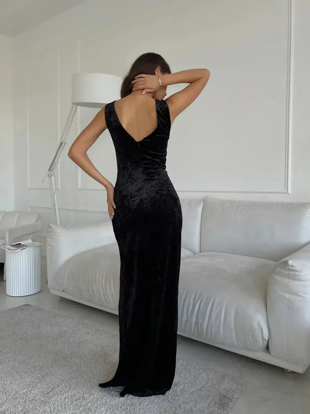 Back view of the Noir Muse Maxi Dress, showcasing its voluptuous velvet fabric and elegant silhouette in black.