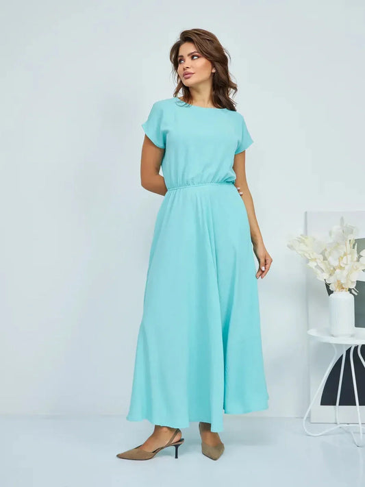 Woman wearing a light blue maxi dress with a relaxed fit and elegant silhouette, perfect for casual or formal occasions.