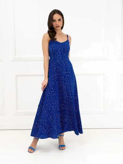 Celeste Maxi Dress in electric blue with polka dots, featuring a flowy silhouette and delicate straps for elegant summer styling.