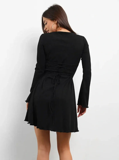 Back view of Noir Laced black long sleeve mini dress with lace-up detail, perfect for cocktail and wedding guest occasions.