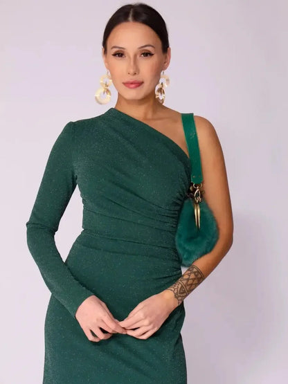 Model wearing the Emerald Spark Maxi Dress featuring a one-shoulder design and shimmering emerald fabric.