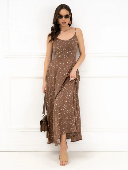 Elegant woman in a brown polka dot maxi dress with a bow back, exuding effortless style and summer charm.