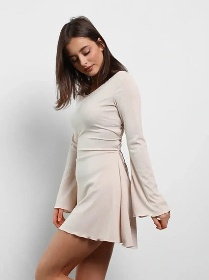 Cream Laced long sleeve mini dress in soft beige, perfect for summer and wedding guest occasions.