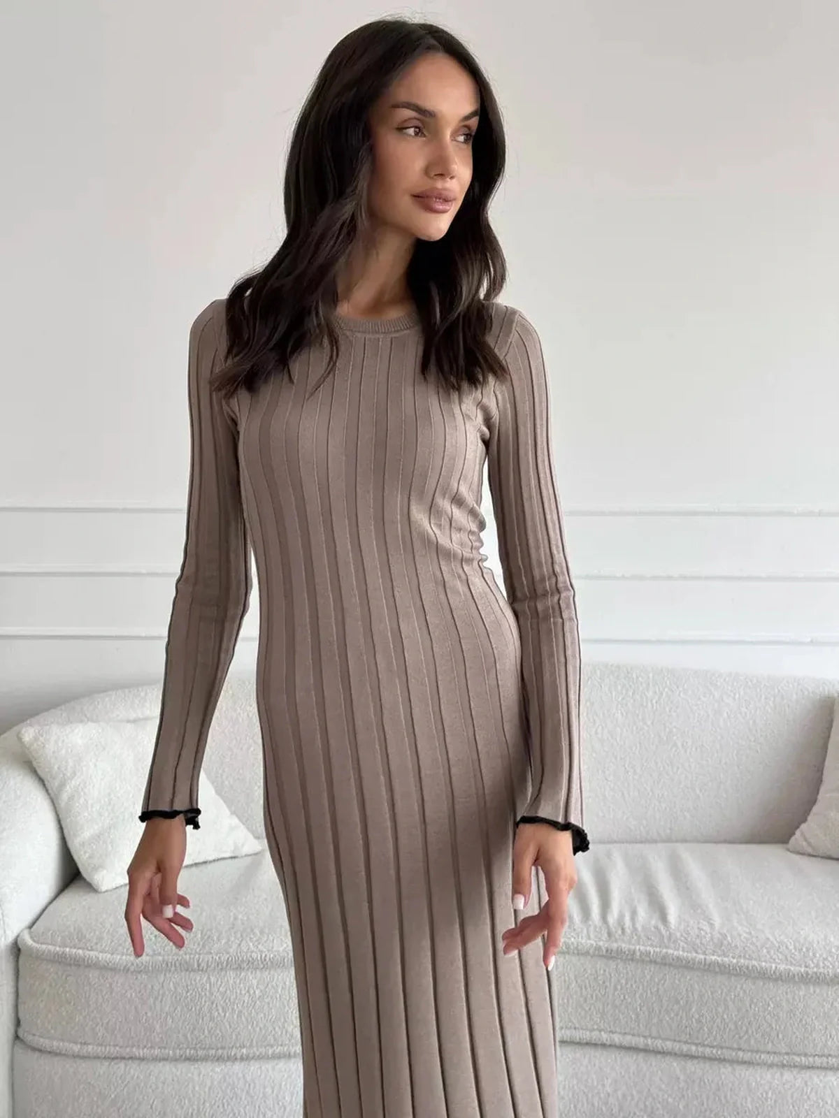 Model showcasing the Contour Maxi Dress in ribbed knit, highlighting its elegant fit and ruffle hem.