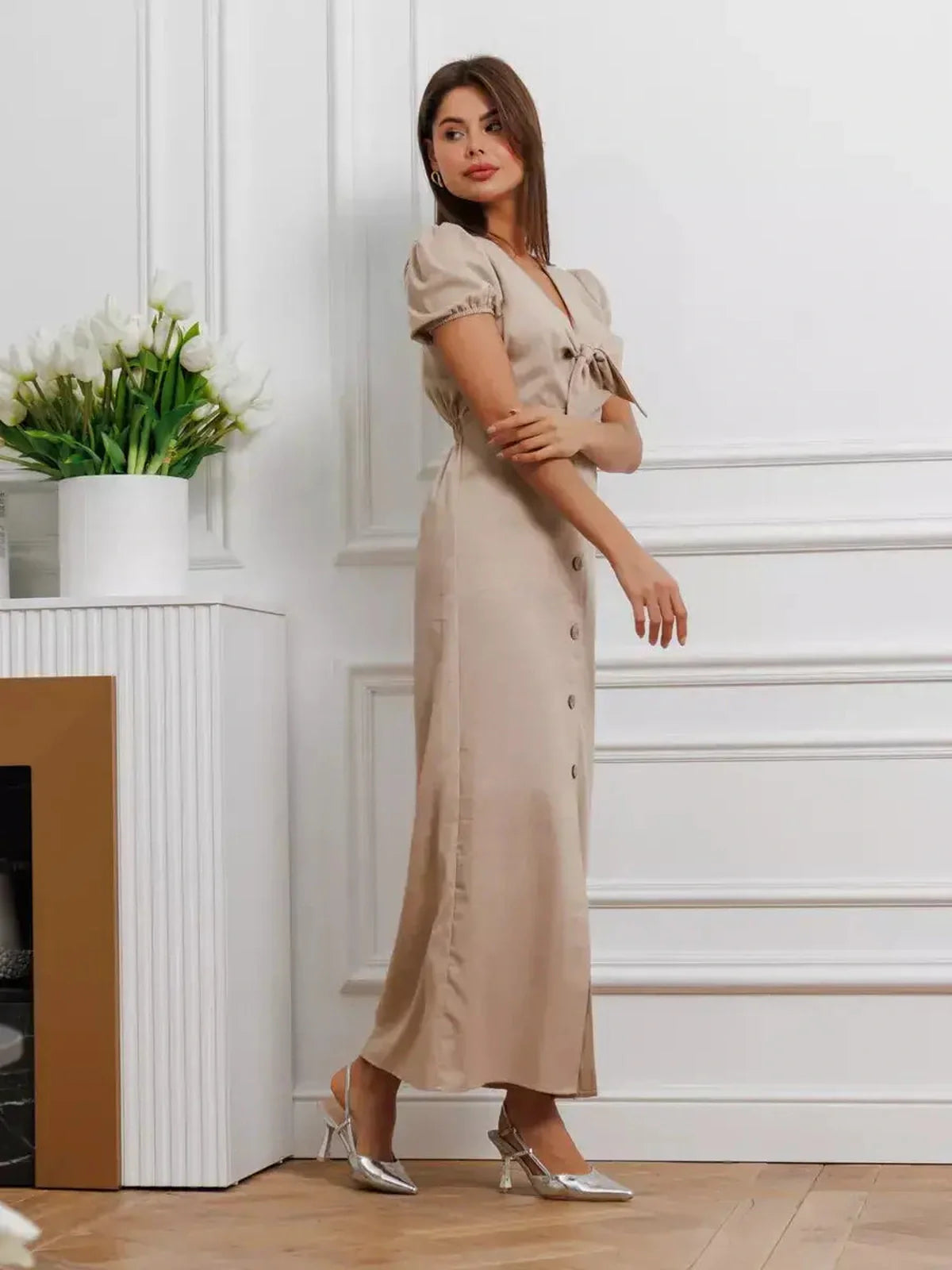 Model wearing the Serene Bond Maxi Dress with puff sleeves and a waist tie, exuding elegance in a soft neutral hue.