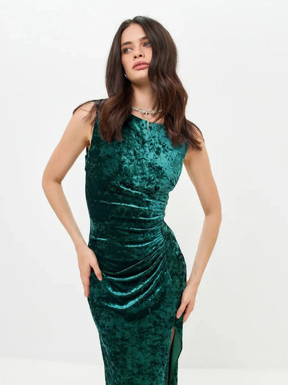 Sleek Velvet Aura Maxi Dress in green with elegant ruching and high slit for evening glamour.