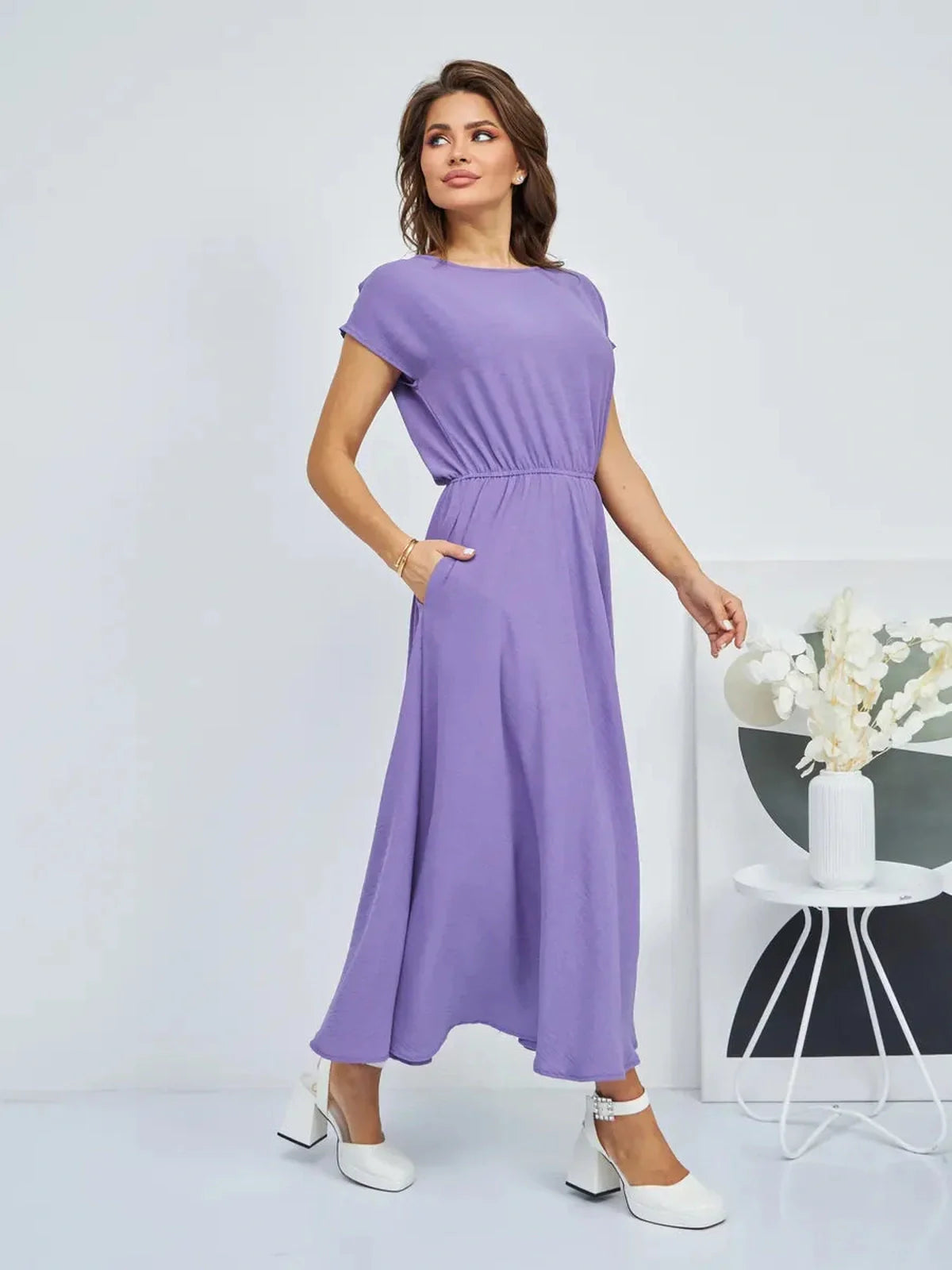 Model wearing Lavender Breeze Maxi Dress in light lavender, showcasing flowing silhouette and soft gathered waist.