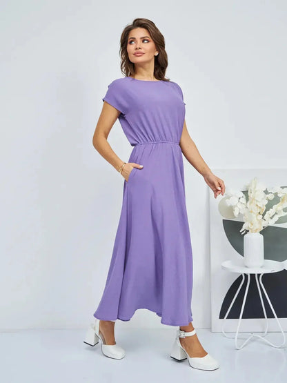 Model wearing Lavender Breeze Maxi Dress in light lavender, showcasing flowing silhouette and soft gathered waist.