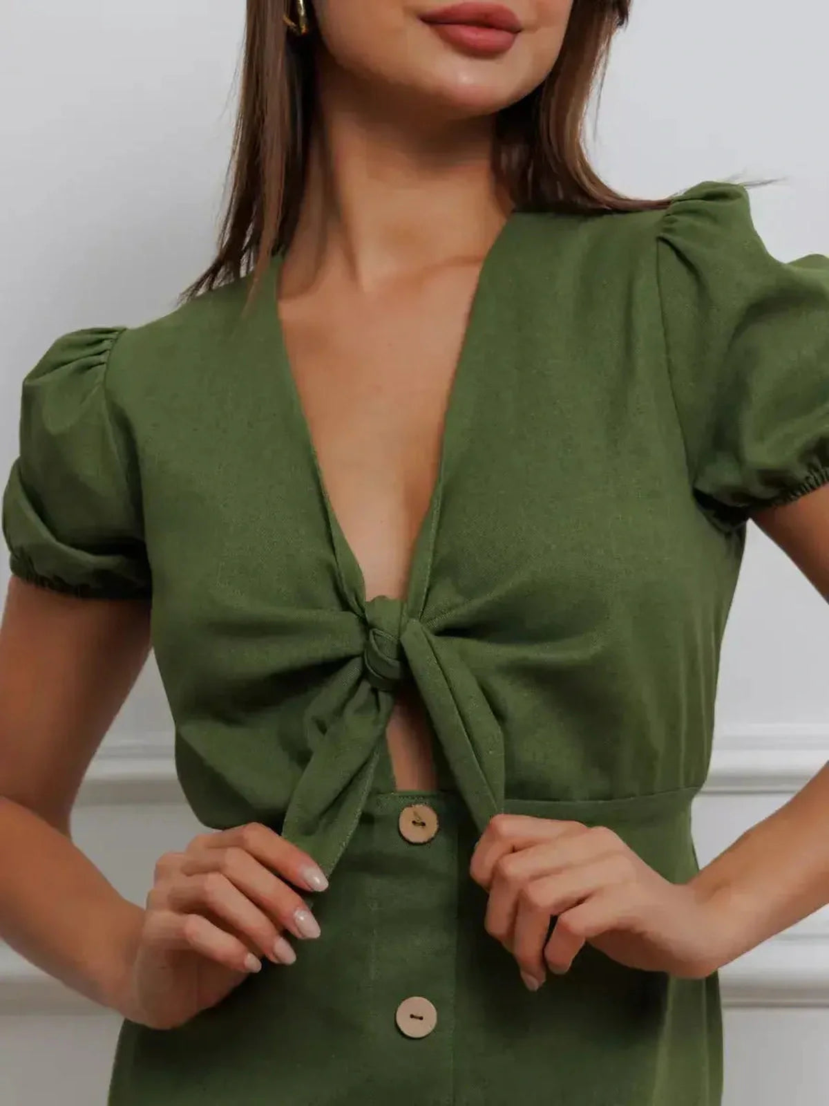 Close-up of the Olive Whisper Maxi Dress featuring puff sleeves and a charming tie front detail.