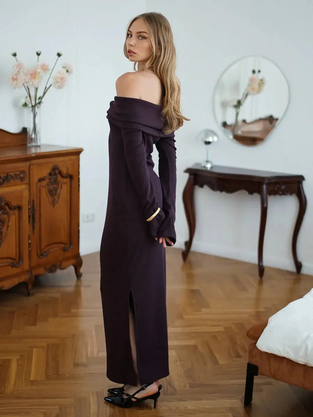 Model showcasing the Elegance Maxi Dress in deep purple, featuring an off-shoulder design and chic ribbed texture.