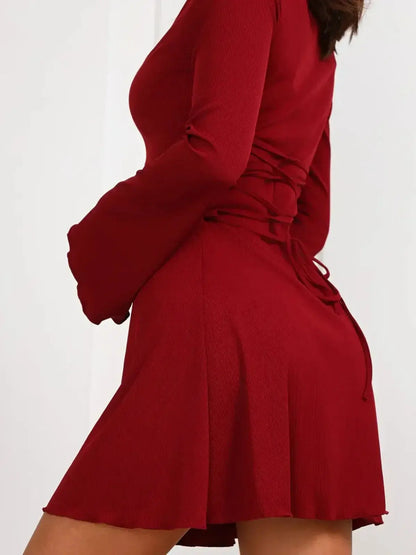 Ruby Laced red mini dress featuring long bell sleeves and corset-style lace-up detail for a bold, elegant look.