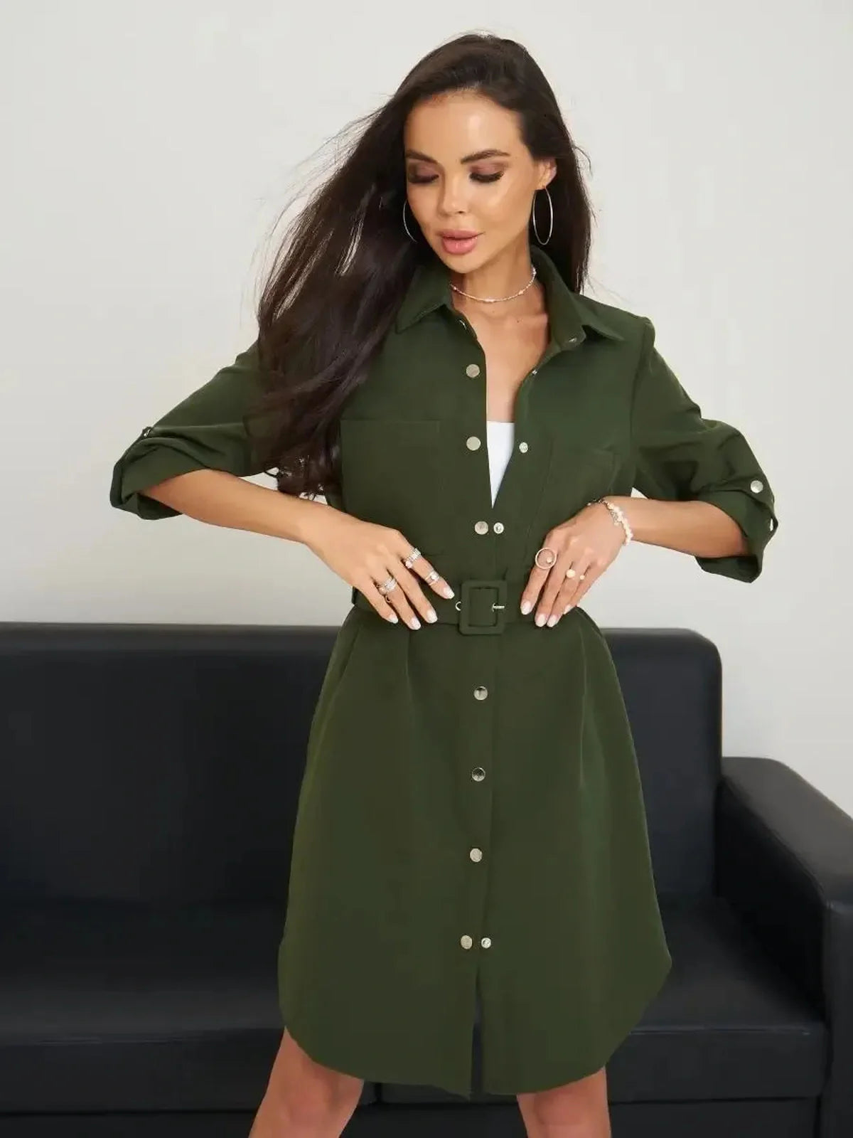 Model wearing an olive green belted shirt mini dress with snap-button front, perfect for urban outings.