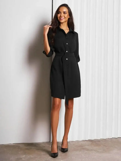 Model showcasing Urban Edit Mini black shirt dress with structured silhouette and detachable belt, perfect for versatile styling.