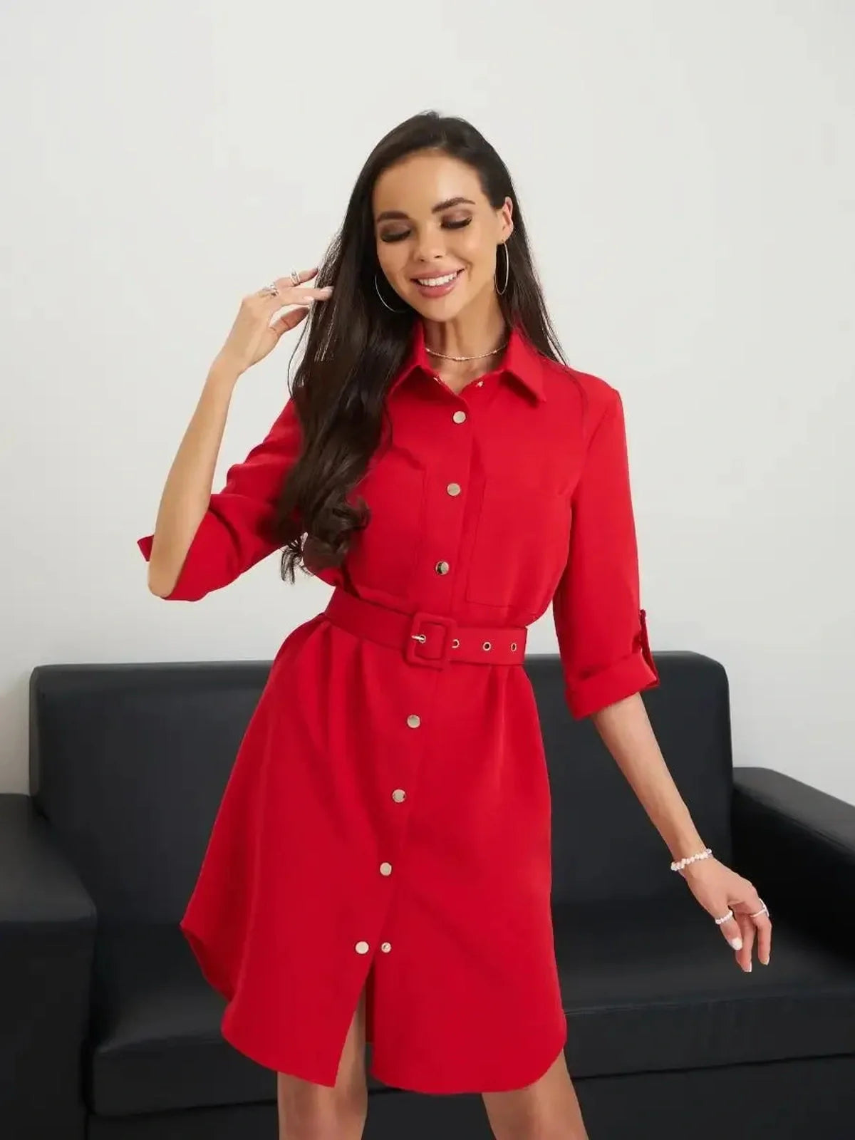 Female model wearing a striking red belted mini dress, showcasing its flattering silhouette and elegant design.