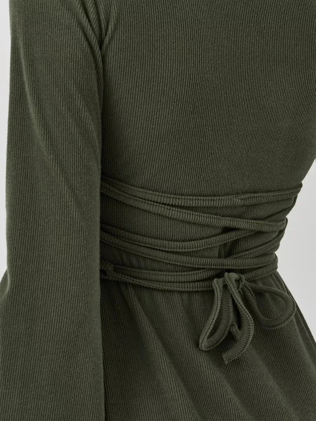 Back view of Ivy Bell mini dress showcasing its stylish waist cinching detail and flared sleeves in premium ribbed knit.