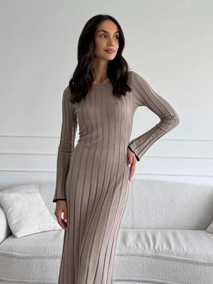 Model showcasing the Contour Maxi Dress in soft ribbed knit, emphasizing its elegant silhouette and long sleeves.