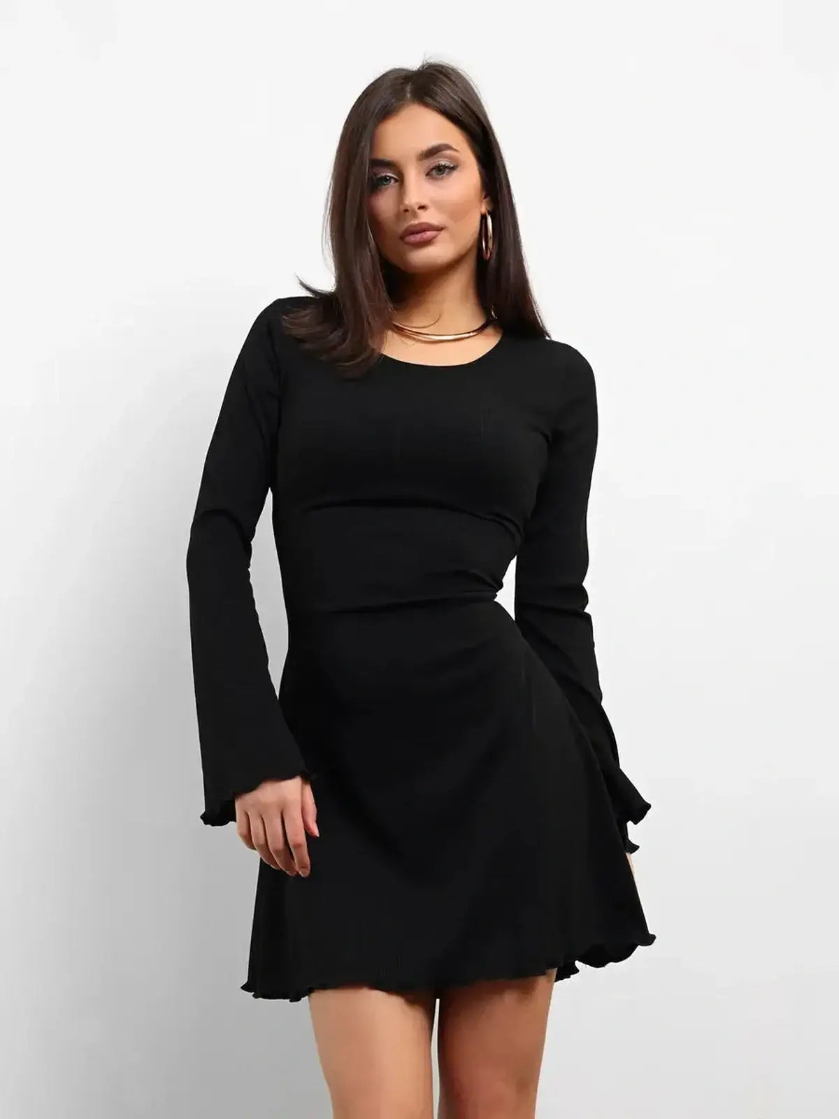 Elegant black mini dress with long flared sleeves, perfect for parties or weddings.