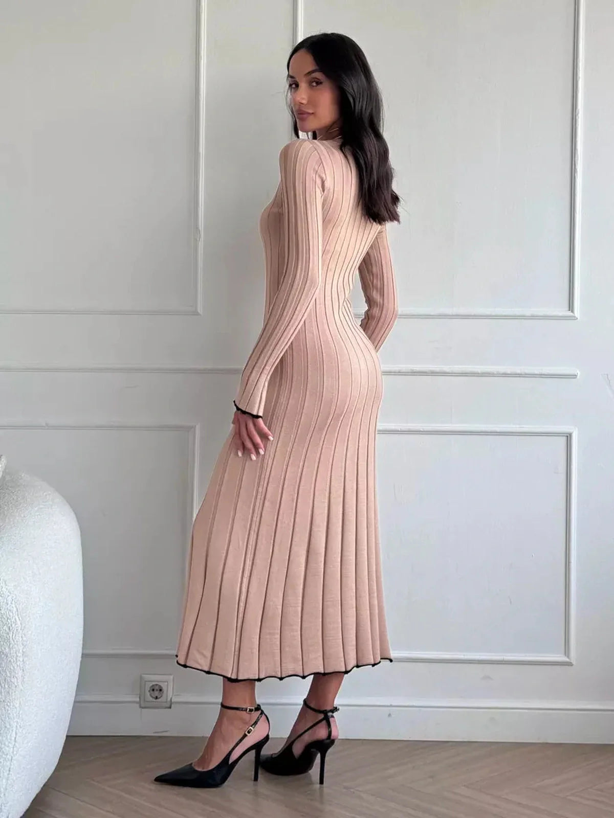 Model showcasing the Sahara Curve Maxi Dress in sandstone beige, featuring a soft ribbed texture and elegant figure-hugging silhouette.