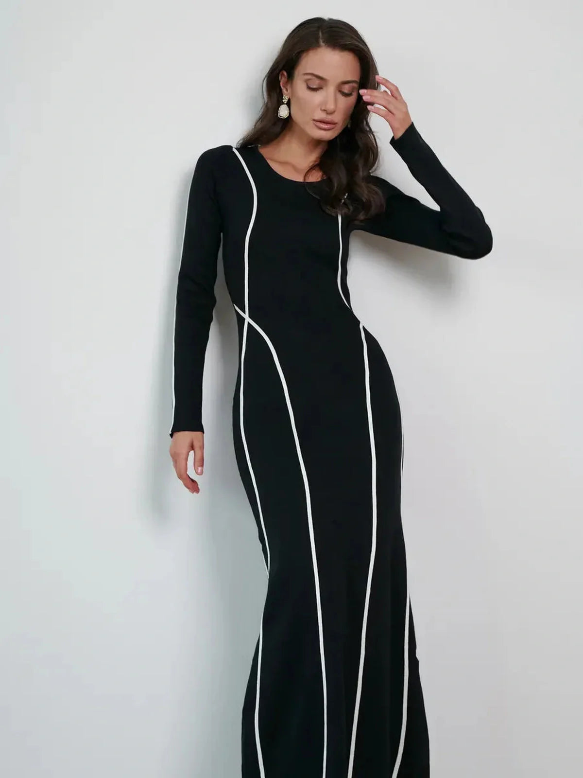 Model wearing the Midnight Curve Maxi Dress with elegant white piping, highlighting a flattering silhouette.