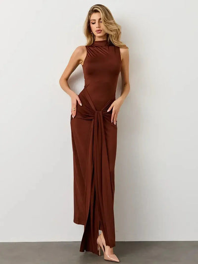 Mocha Muse Maxi Dress featuring a sculptural fit, elegant high neckline, and a draped front knot in a rich earthy tone.