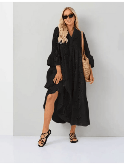 Woman wearing a Midnight Broderie Maxi Dress with a flowy silhouette and broderie anglaise detailing. Perfect for any occasion.