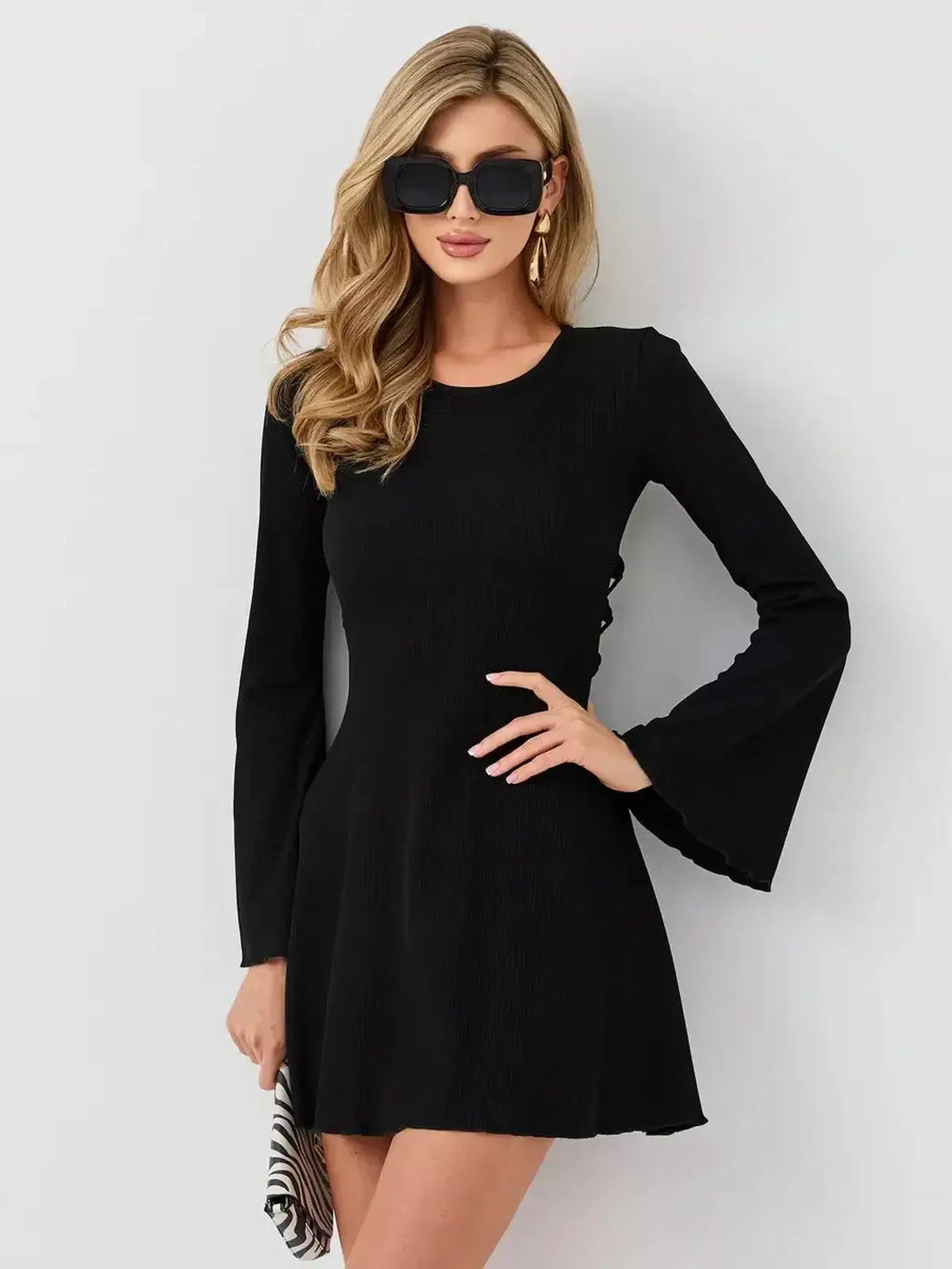 Black long sleeve mini dress with flared cuffs, perfect for cocktail events, summer weddings, and formal occasions.